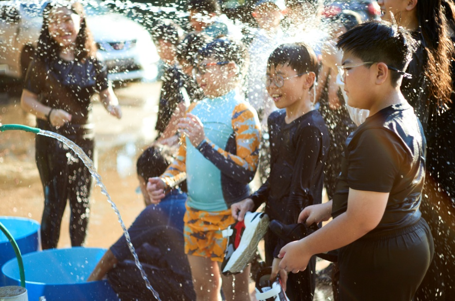 Students enjoying a water-based outdoor activity during a school camp.